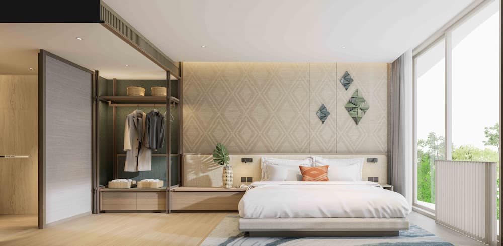 a bedroom with a bed and clothes on the wall